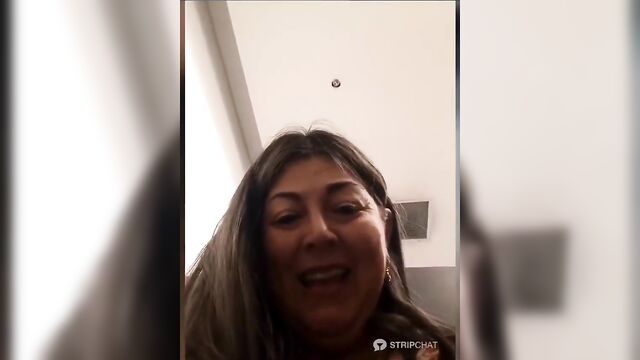 A hot mature woman shows her body to the guy in public