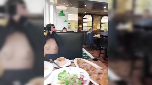 Asian woman flashing her boobs in a restaurant for money