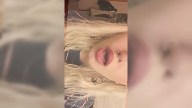 A seductive girl with red lips and a piercing gaze promotes her of video