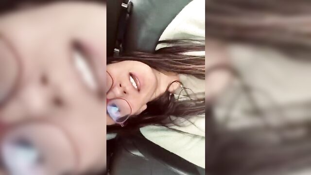 A woman with long hair has sex in public car